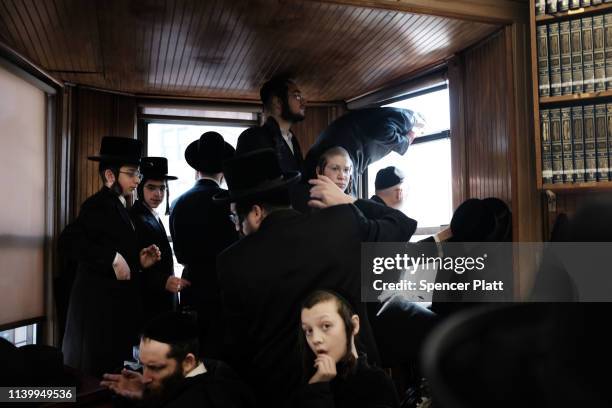 People gather in a yeshiva as thousands of mourners gather in Borough Park for the funeral of The Skulener Rebbe, Rabbi Yisroel Avrohom Portugal who...