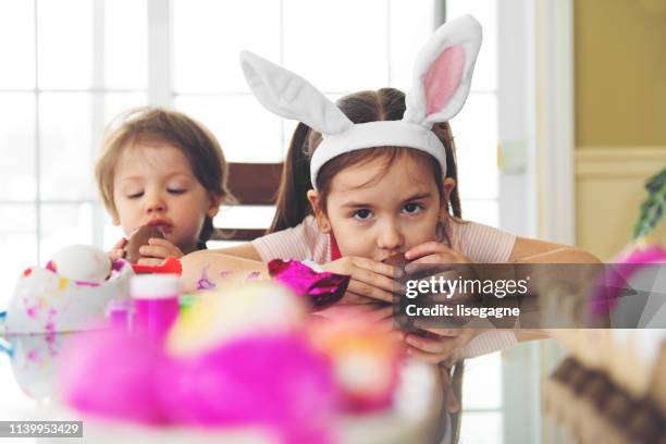 sister and brother eating chocolate - dirty easter stock pictures, royalty-free photos & images