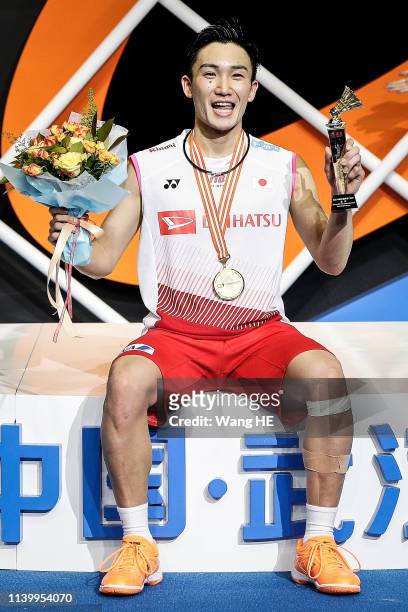 Kento Momota of Japan pose with gold medals on the podium after winning the men's singles final match against Shi Yuqi of China at the 2019 Badminton...