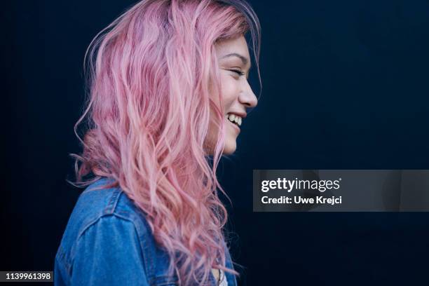 young woman against black background - pink hair stock pictures, royalty-free photos & images