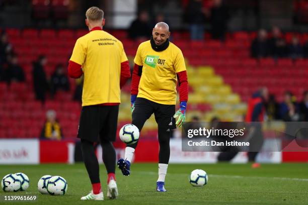 Heurelho Gomes of Watford is seen wearing a Kick It Out T-shirt as he warms up prior to the Premier League match between Watford FC and Fulham FC at...