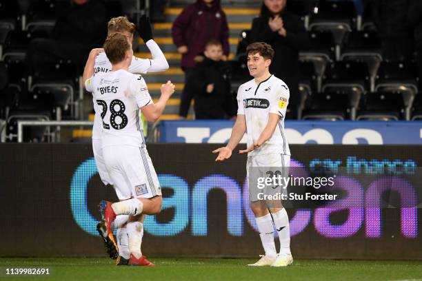 Daniel James of Swansea City celebrates with teammates after scoring his team's third goal during the Sky Bet Championship between Swansea City and...