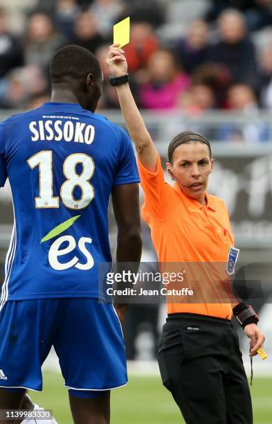 First woman to referee a Ligue 1 match Stephanie Frappart gives a yellow card to Ibrahima Sissoko of Strasbourg during the French Ligue 1 match...
