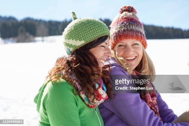women enjoying day out in snow - middle aged woman winter stockfoto's en -beelden