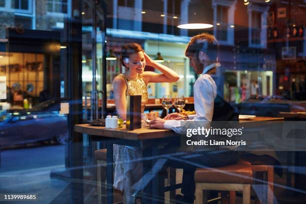 couple sitting in restaurant - london nightlife stock pictures, royalty-free photos & images