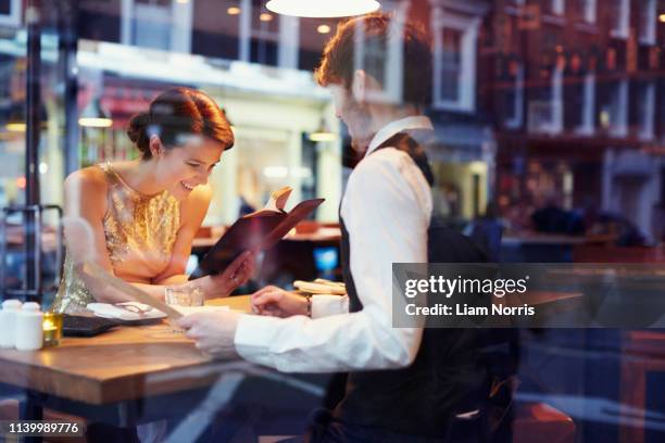 couple reading menu in restaurant - couple choosing stock pictures, royalty-free photos & images