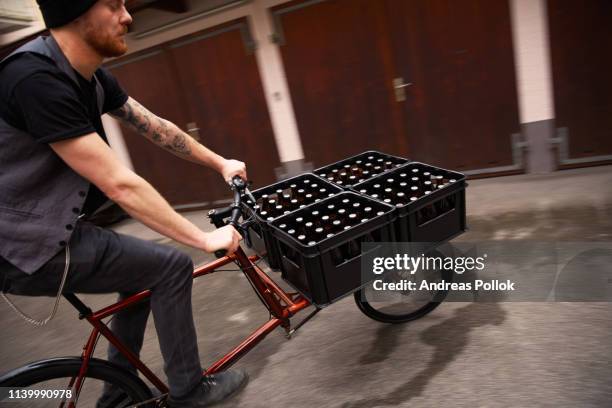 man delivering beer on bicycle, munich, bavaria, germany - bicycle top view stock-fotos und bilder