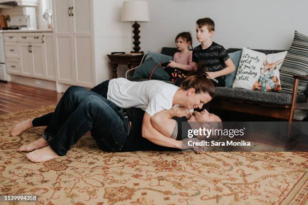 children playing video game, parents wrestling at home - girl wrestling stock pictures, royalty-free photos & images