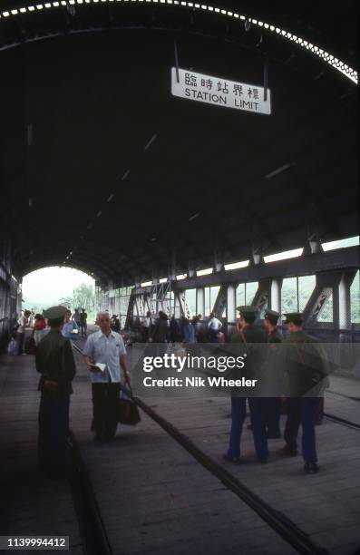 Passengers from Hong Kong cross railroad bridge on the Canton to Kowloon Railway at Luohu border crossing into China, then an international border,...