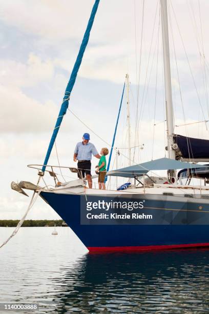 boy and proud grandfather on sailboat - kid sailing imagens e fotografias de stock