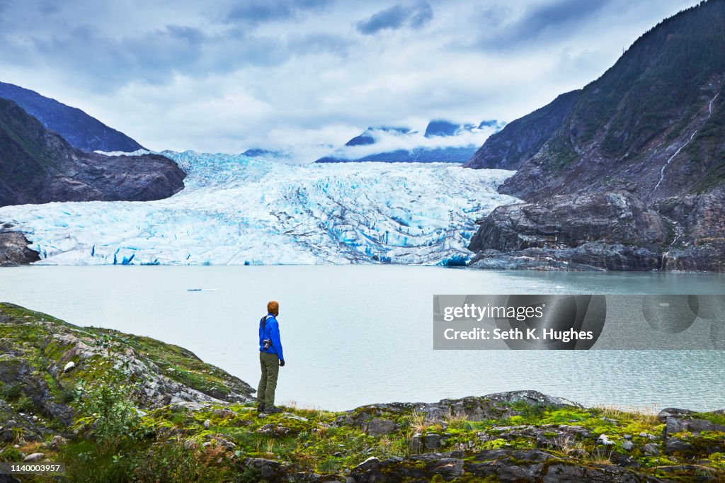Male hiker gazing at Mendenhall Glacier, Juneau, Alaska, USA