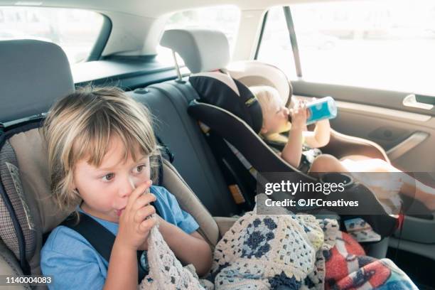 two boys in car seats - thumb sucking stock pictures, royalty-free photos & images