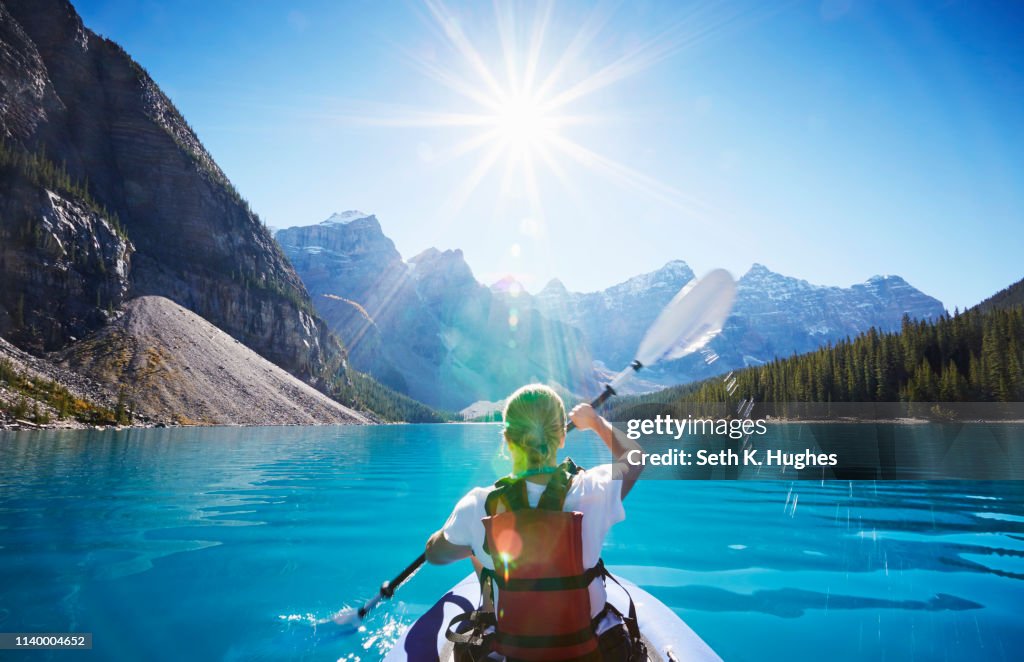 Mid adult woman kayaking, Moraine Lake, Alberta, Canada