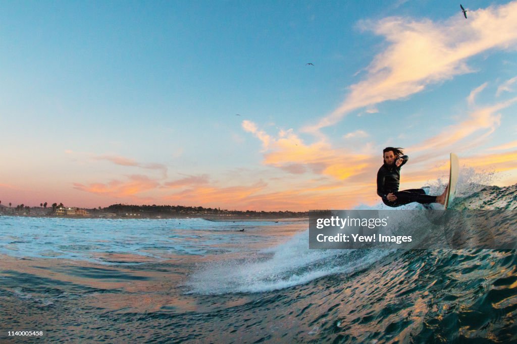 Young male surfer surfing a wave, Cardiff-by-the-Sea, California, USA