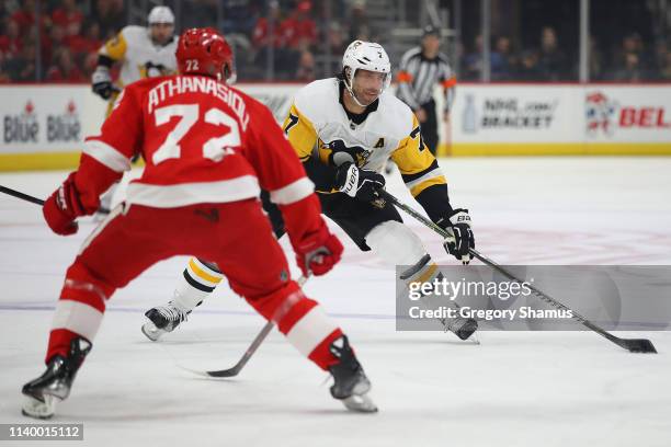 Matt Cullen of the Pittsburgh Penguins looks to get a shot off behind Andreas Athanasiou of the Detroit Red Wings during the first period at Little...