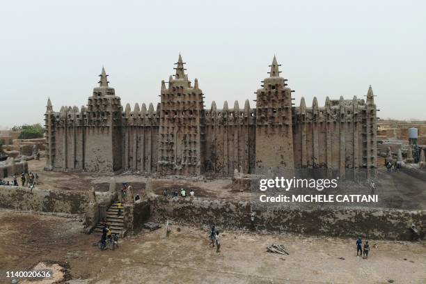 Picture shows the Great Mosque of Djenne in central Mali during its annual rendering ceremony on April 28, 2019. - Several thousand residents of the...