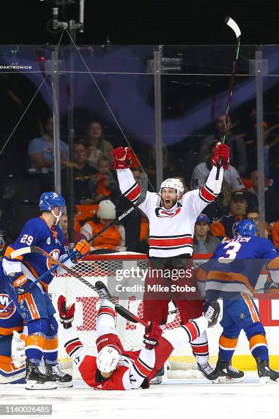 Jordan Staal celebrates with Nino Niederreiter of the Carolina Hurricanes who scored a third period goal against the New York Islanders in Game One...