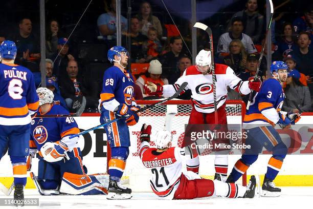 Nino Niederreiter of the Carolina Hurricanes is congratulated by his teammate Jordan Staal after scoring a third period goal as Robin Lehner, Brock...
