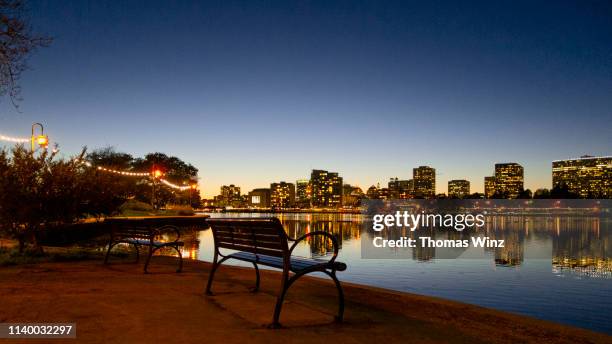 oakland skyline and lake merritt at dusk - lake merritt stock pictures, royalty-free photos & images