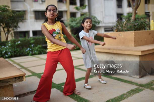 two girls dancing outdoors in the park - dancer india foto e immagini stock