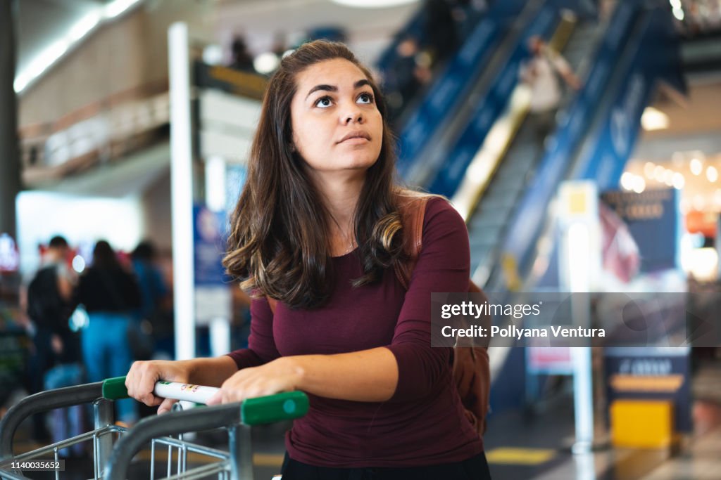 Anxious tourist looking at flight instructions