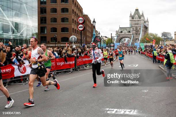 Crowds of athletes cross Tower Bridge during the Virgin Money London Marathon in London, England on April 28, 2019. Nearly 43 thousand runners...