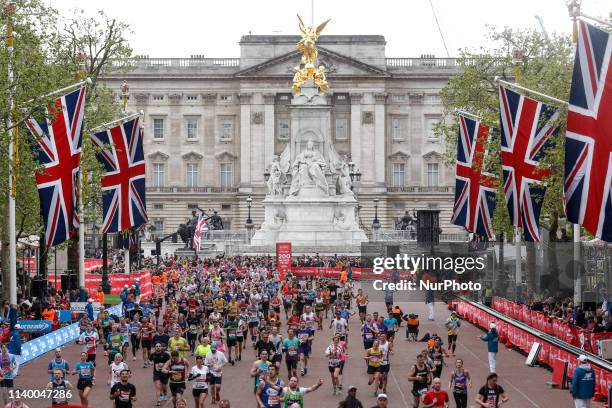 Crowds of athletes take the finishing straight in front of the Buckingham Palace during the Virgin Money London Marathon in London, England on April...