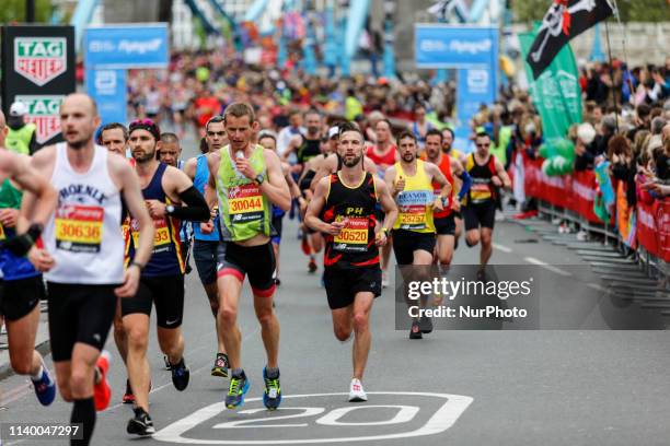 Crowds of athletes cross Tower Bridge during the Virgin Money London Marathon in London, England on April 28, 2019. Nearly 43 thousand runners...