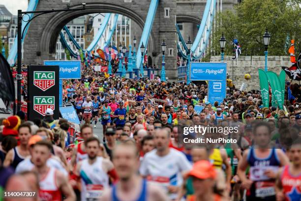 Crowds of athletes cross Tower Bridge during the Virgin Money London Marathon in London, England on April 28, 2019. Nearly 43 thousand runners...