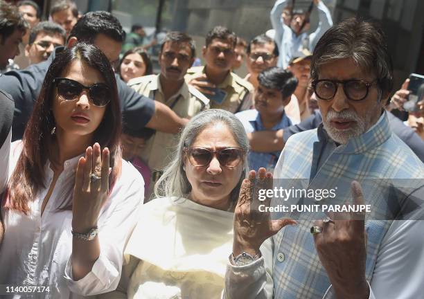 Bollywood actors Amitabh Bachchan , wife Jaya and daughter in law Aishwarya Rai Bachchan pose for a picture after casting their vote at a polling...