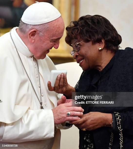 Pope Francis exchanges gifts with mother of Togo's President Faure Essozimna Gnassingbe Eyadema, Sabine Mensah at the end of their private meeting at...