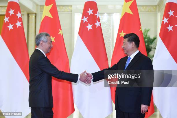 Singapore's Prime Minister Lee Hsien Loong, left. Shakes hands with China's President Xi Jinping before their meeting at the Great Hall of the People...