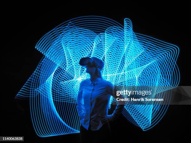 young woman with vr glasses - virtual stock pictures, royalty-free photos & images