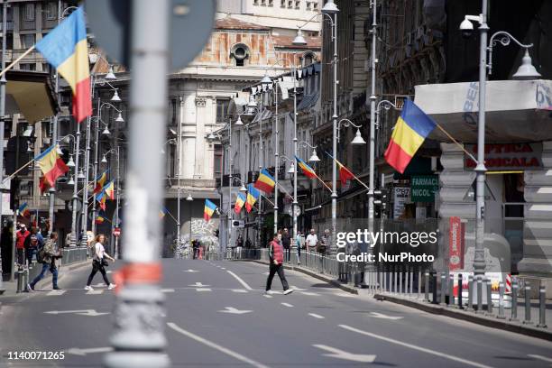 Romanian flags are seen on an empty street in central Bucharest, Romania on April 29, 2019.