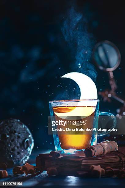 half moon in a teacup. double wall glass with a shining crescent. magical tea concept with copy space - liquid galaxy stock pictures, royalty-free photos & images