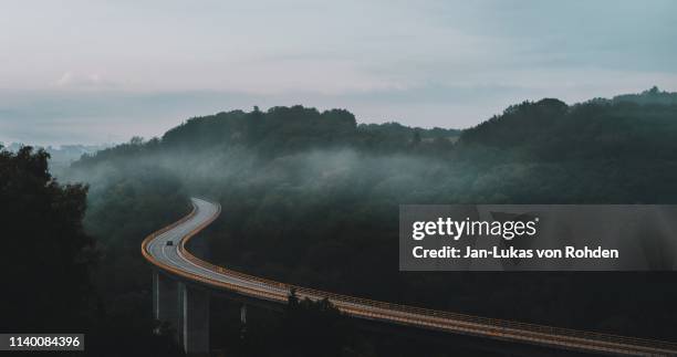 car drives along the bridge - street curve bildbanksfoton och bilder