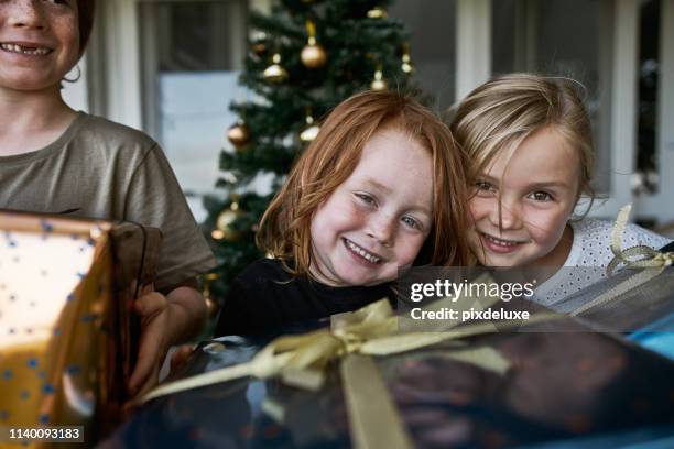 time for gifts! - sibling christmas stock pictures, royalty-free photos & images