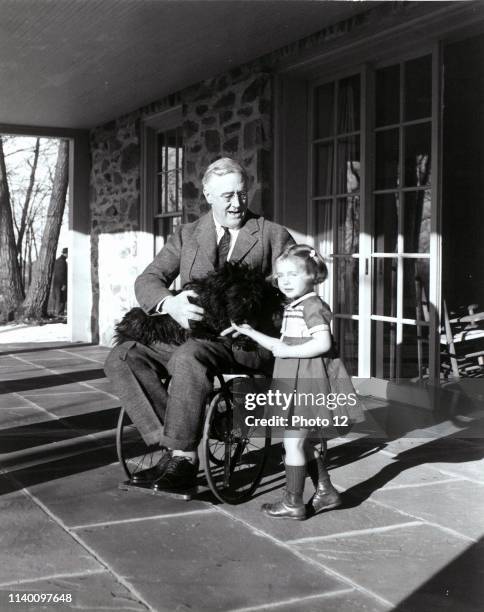 Franklin D. Roosevelt with Fala his dog and Ruthie Bie in Hyde Park, New York, 1941. There were few images taken showing President Roosevelt in his...