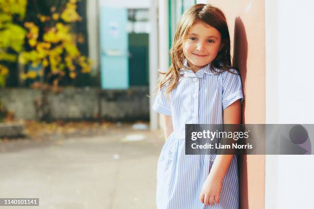 portrait of elementary schoolgirl in playground - white dress stock pictures, royalty-free photos & images