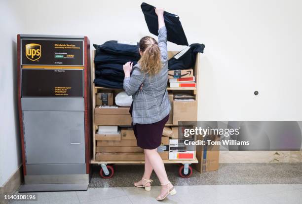 An aide places a Rent the Runway bag at a UPS dropbox station outside the U.S. Post Office in Longworth Building on Monday, April 29, 2019.