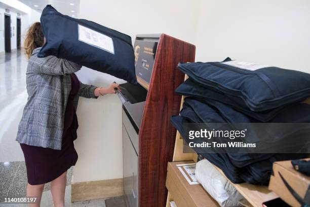An aide places a Rent the Runway bag in a UPS dropbox station outside the U.S. Post Office in Longworth Building on Monday, April 29, 2019.