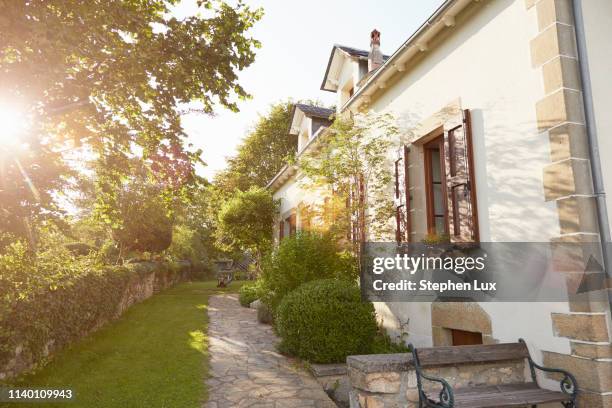 rural cottage and garden in sunlight - french garden stock-fotos und bilder