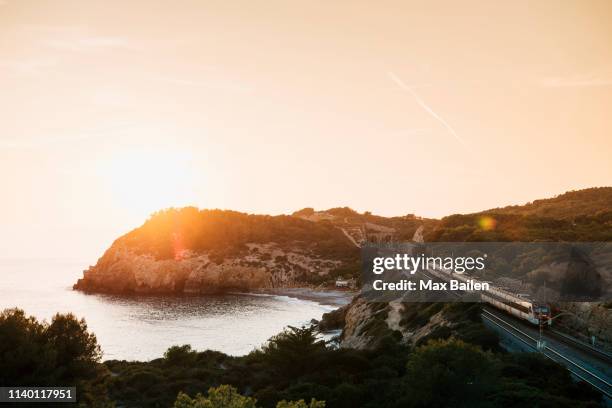sunset over seaside, sitges, catalonia, spain - barcelona province stock pictures, royalty-free photos & images