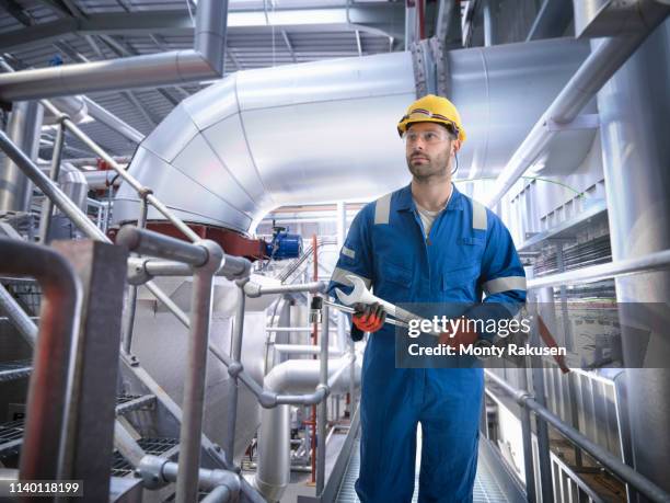 composite image of engineer in gas power station - coveralls - fotografias e filmes do acervo