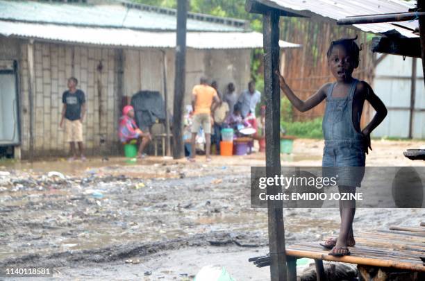 Little girl stands on the porch of her house in the Paquite district of Pemba on April 29 as Cyclone Kenneth hit northern Mozambique, killing 38 and...