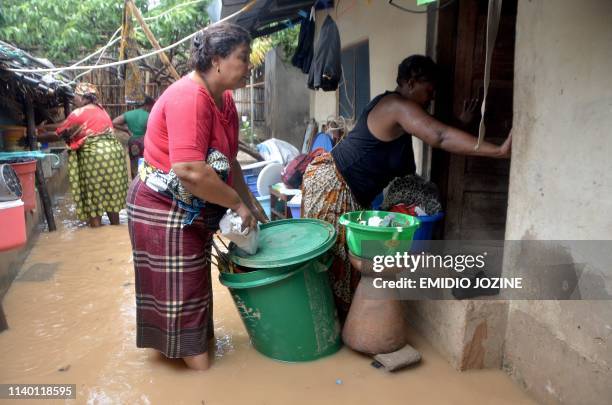 Residents try to salvage their belongings in the Paquite district of Pemba on April 29 as Cyclone Kenneth hit northern Mozambique, killing 38 and...