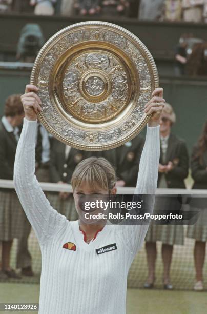 American tennis player Chris Evert Lloyd holds up the Venus Rosewater Dish trophy after beating Czechoslovak tennis player Hana Mandlikova 6-2, 6-2...