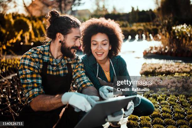 couple using digital tablet - garden ipad stock pictures, royalty-free photos & images