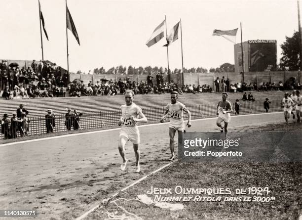 Paavo Nurmi and Ville Ritola of Finland in the lead for the Finland team to finish in first place in semifinal 1 of the Men's 3000 metres team race...