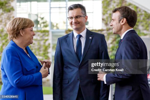 German Chancellor Angela Merkel and French President Emmanuel Macron greet Prime Minister Slovenia Marja Sarec upon his arrival at the Chancellery...